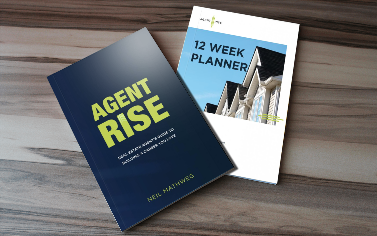 Two books on a wooden table, one titled 'AGENT RISE' by Neil Mathweg and another titled '12 WEEK PLANNER' by Agent Rise."